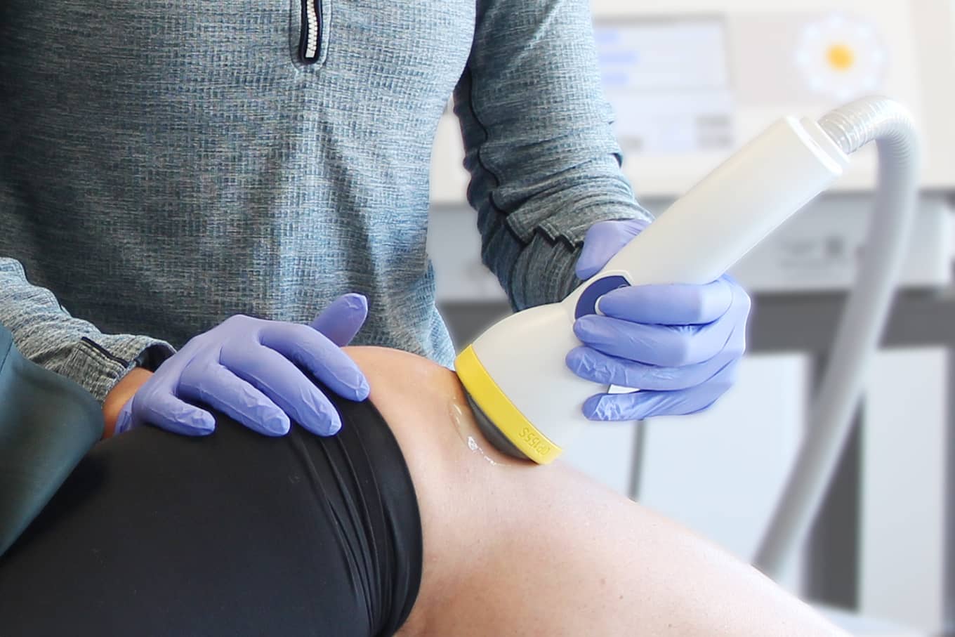 Close-up of shockwave therapy device applied to the knee for pain and tissue repair